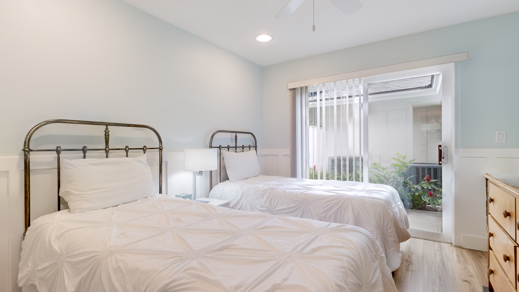 The second guest bedroom with two beds and a view.