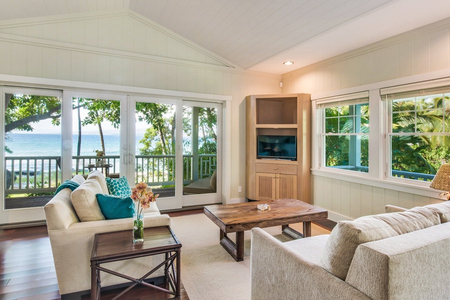 Ohana Guest Cottage Living Room with Split Air-Conditioning, Flat Guest Ohana Guest Cottage Living Room Furnished w/ Comfy Sofas and Queen Sleeper Sofa, Flat Screen Smart TV, Sliding Glass Doors to Private Lanai w/ Stunning Ocean and Garden Views