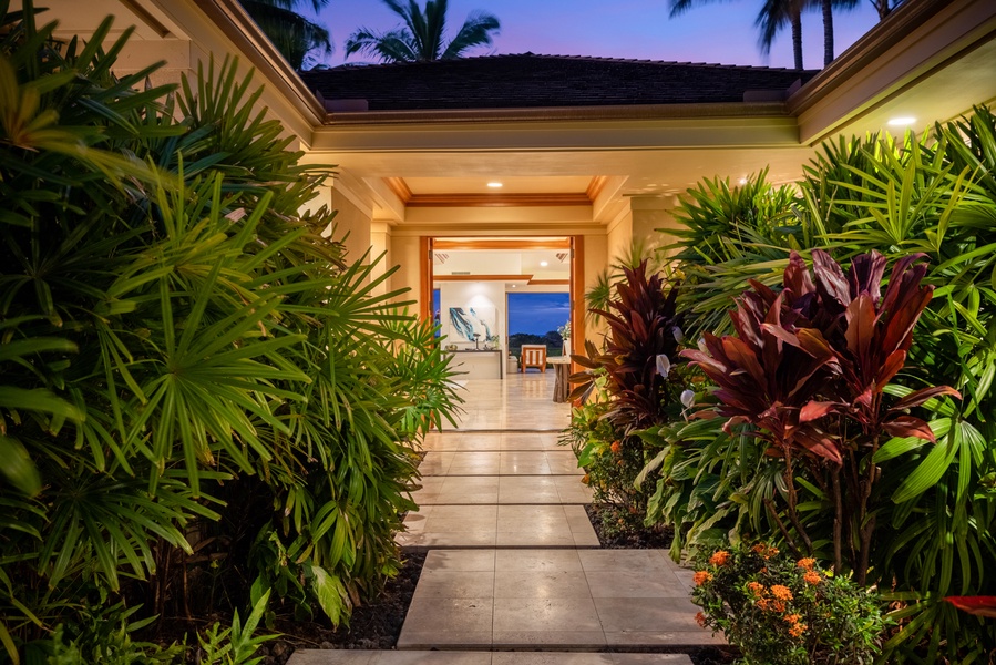 Interior entrance walkway with lush tropical landscaping.