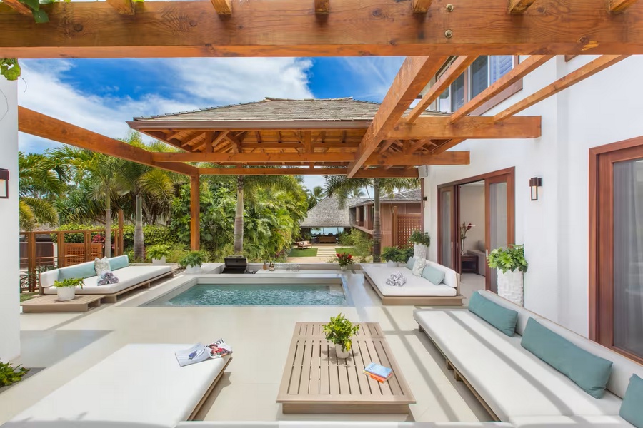 Afternoons stretch long under the wood pergola, the heated pool off the shaded lounge.