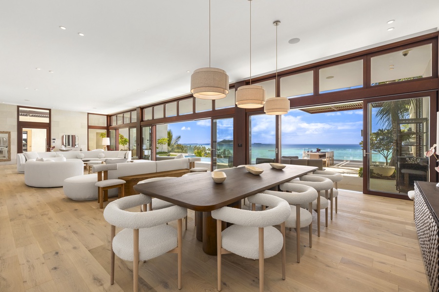 Spacious dining table and living room with ocean views, perfect for shared meals and conversations.