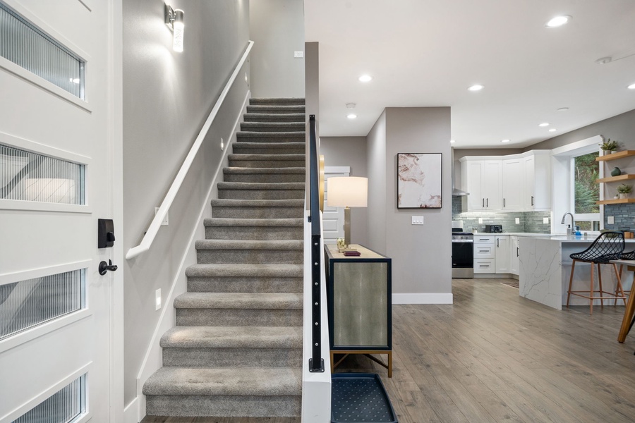 Step into your spacious open-concept retreat where modern design meets comfort, featuring sleek kitchen amenities and elegant living space.