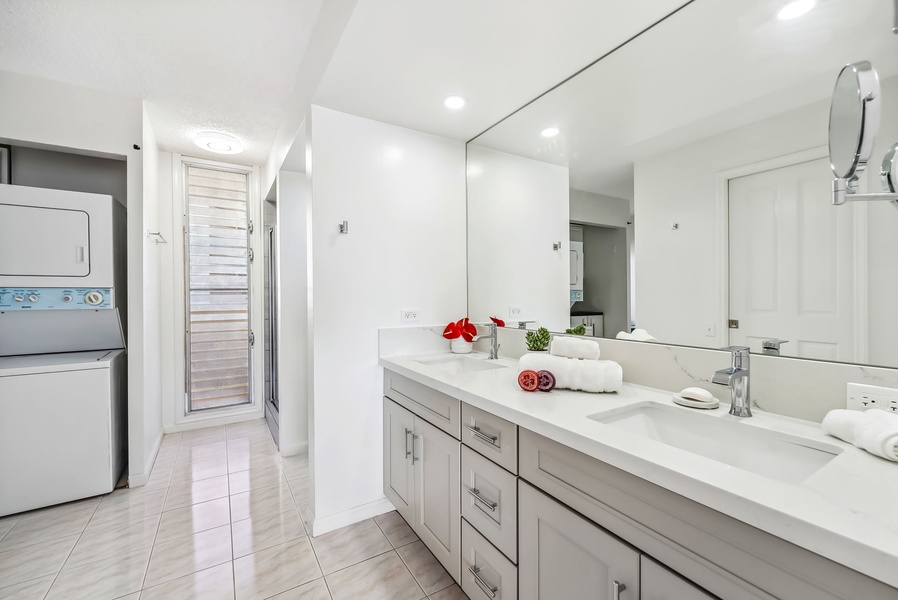 The shared bathroom has dual vanity spaces.