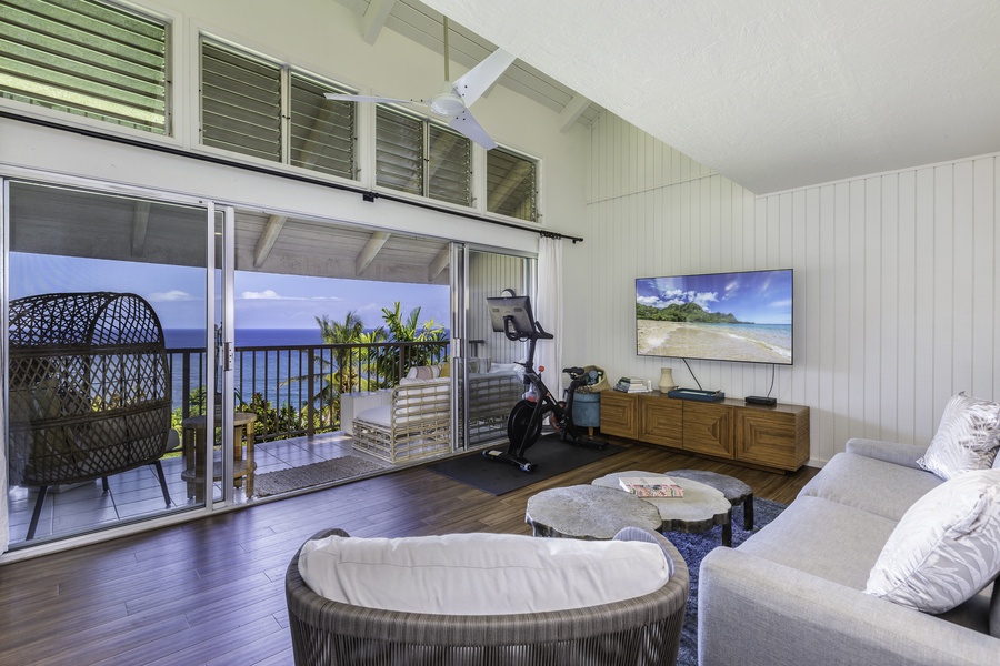 In the living room, you are greeted with a cozy sleeper sofa, tasteful Hawaiian artwork and a large flat screen TV.