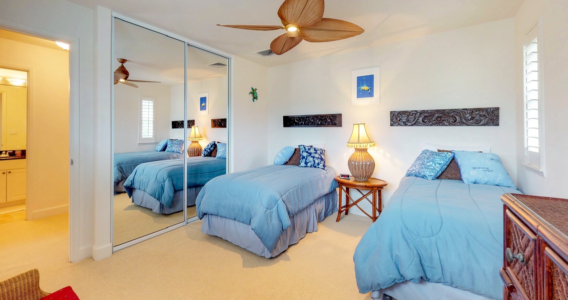 Bedroom with twin beds with soft, blue linens
