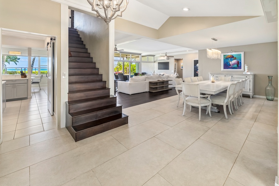 The bright open-concept living and dining area with modern finishes and sleek staircase.