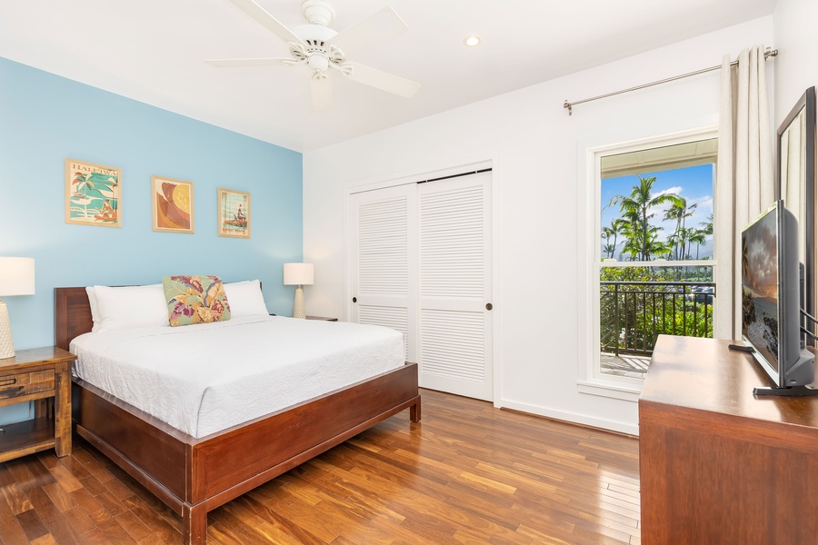 Bright coastal bedroom with tropical palm views from your lanai.