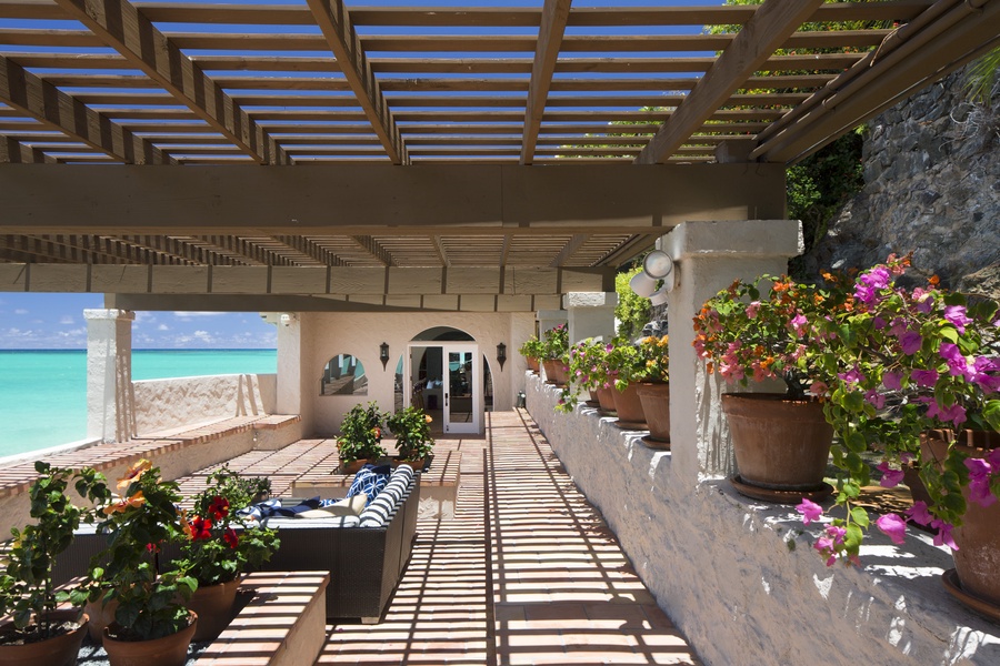 Beachfront bliss with a shaded lanai and outdoor living area.