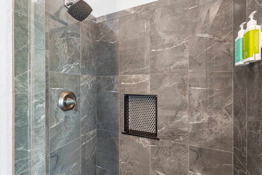 Walk-in shower with elegant tile—refresh after beach days in comfort and style.