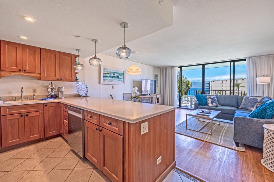 The kitchen opens up to the living room, providing a spacious and connected area for cooking and relaxing with a view.