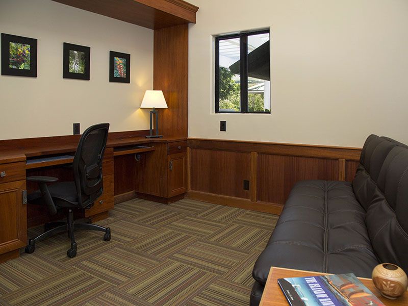 Guest bedroom has a desk and a full size convertible bed