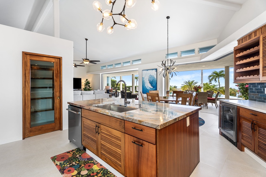 Central island with granite countertops and dual sinks, a social hub for prepping, sipping wine, or sharing morning coffee with a view.