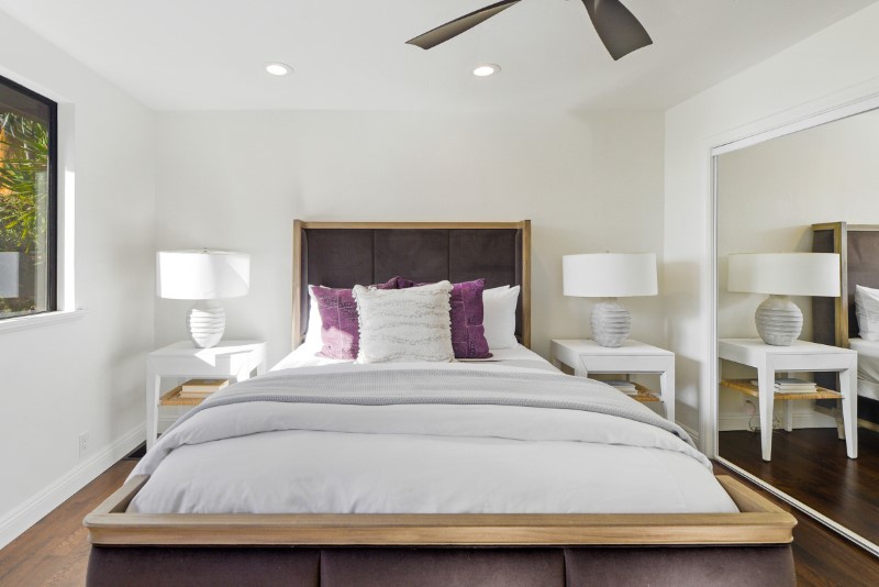 Embrace tranquility in Bedroom 2, featuring a plush double bed nestled amidst a refreshing white decor.