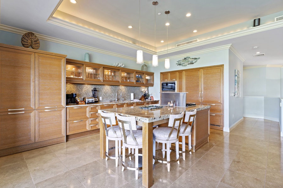 Modern kitchen with granite countertops, bar seating, and custom wood cabinetry, offering a perfect space for preparing and enjoying meals together.