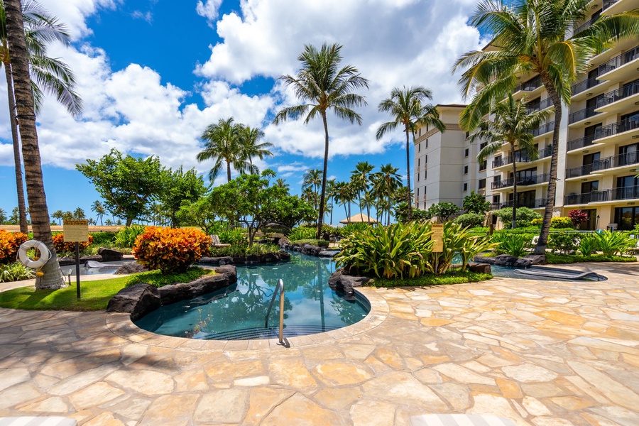 Tropical paradise awaits with a stunning lagoon-style pool surrounded by swaying palms and lush gardens.