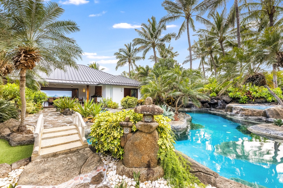 Cross a private footbridge over a peaceful koi pond on your way to the pool.
