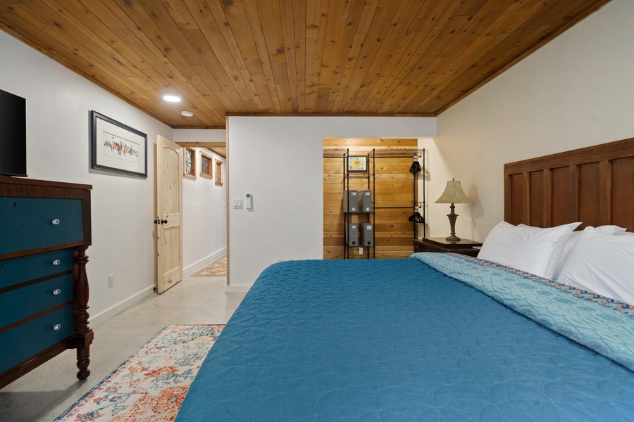 Spacious layout and warm wood ceilings give this king bedroom a peaceful, retreat-like feel.