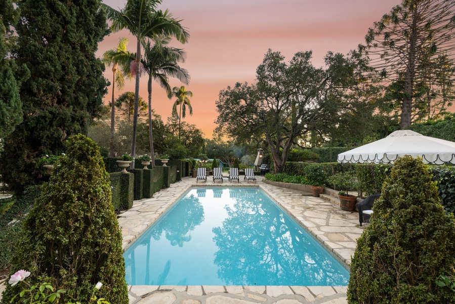 A stunning sunset pool area showcases tropical landscaping and pristine waters for ultimate relaxation.