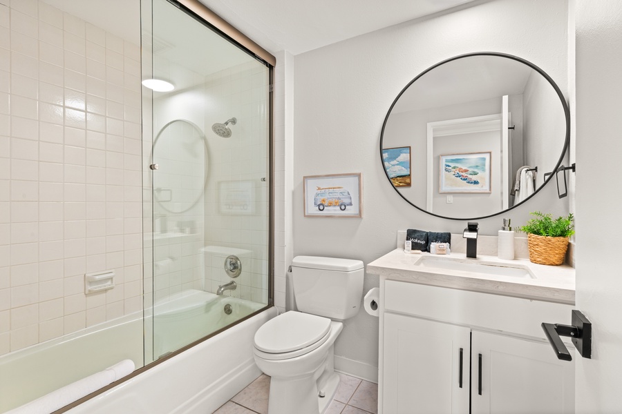 Bright and modern bathroom with a full tub—ideal for a calming soak after a beach day.