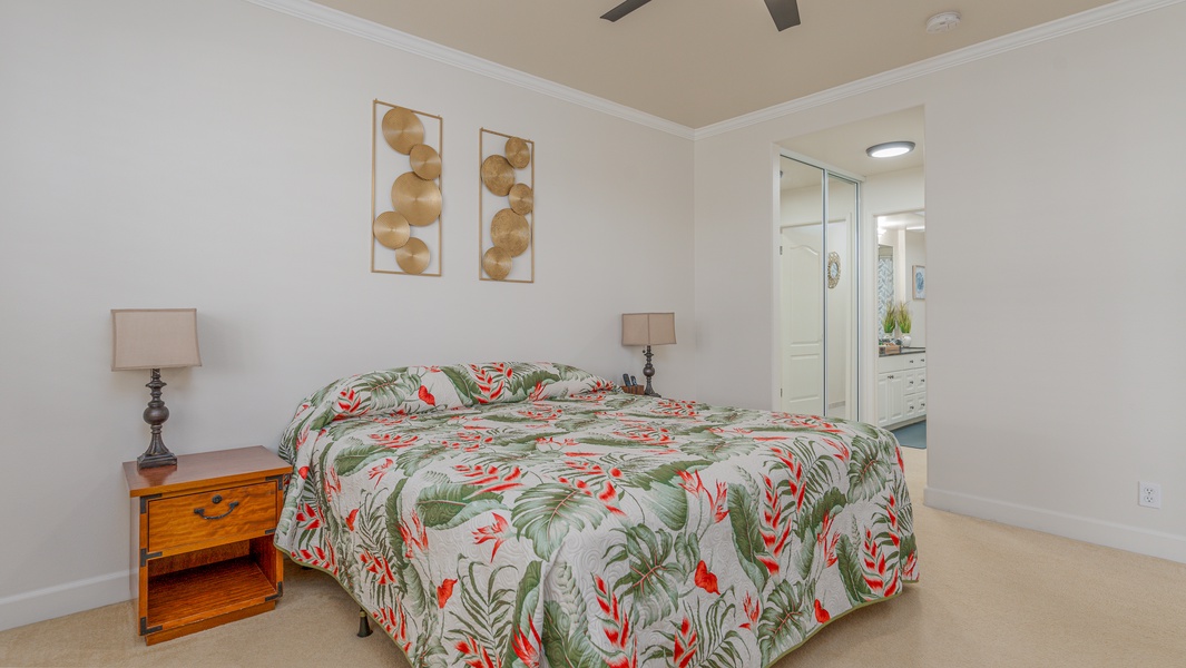 The primary guest bedroom features tropical prints and the comforts of home.