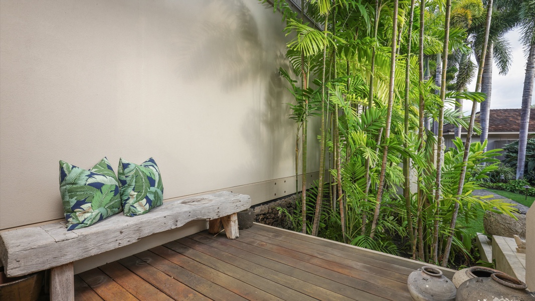 Peaceful outdoor nook with a bamboo backdrop and island-inspired bench.