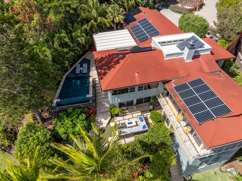 The estate’s thoughtful layout includes outdoor lounges, pool, gardens, and sustainable features.