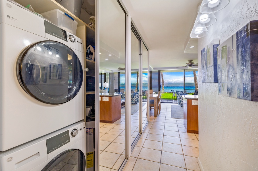 This hallway is equipped with a convenient washer and dryer, tucked away behind sleek mirrored doors