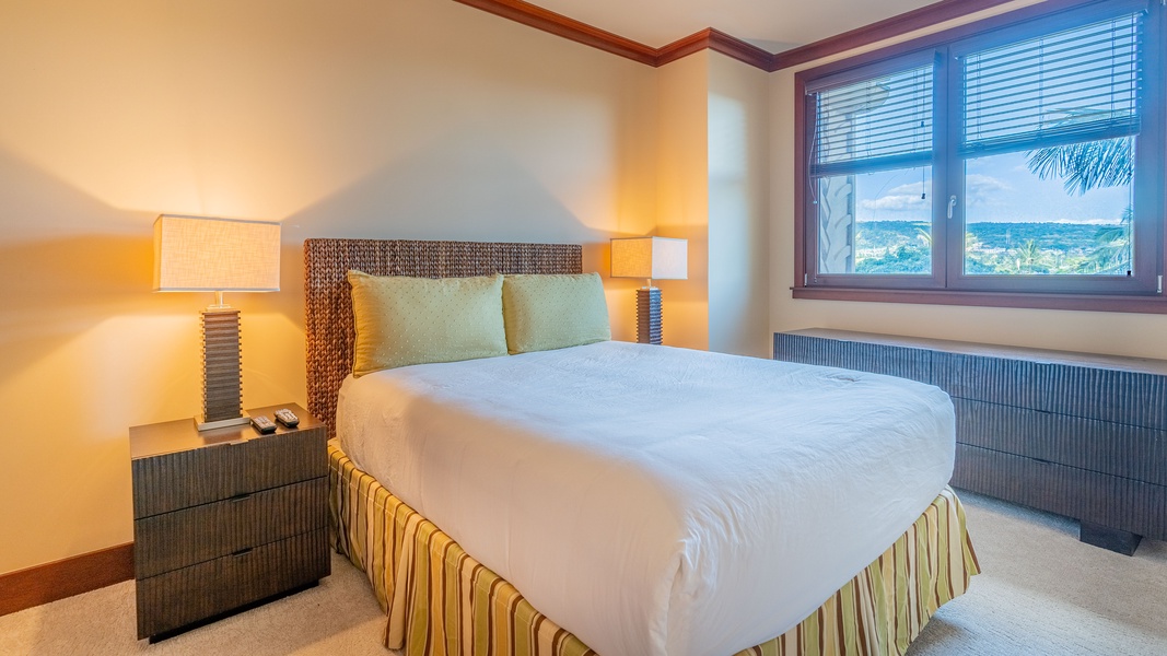 Relax in the second guest bedroom with soft lighting and serene views.