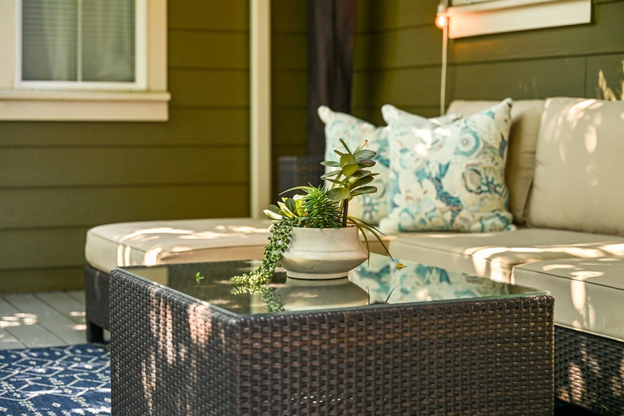 Enjoy your morning coffee or evening wine on this cozy outdoor lounge space with comfortable seating.