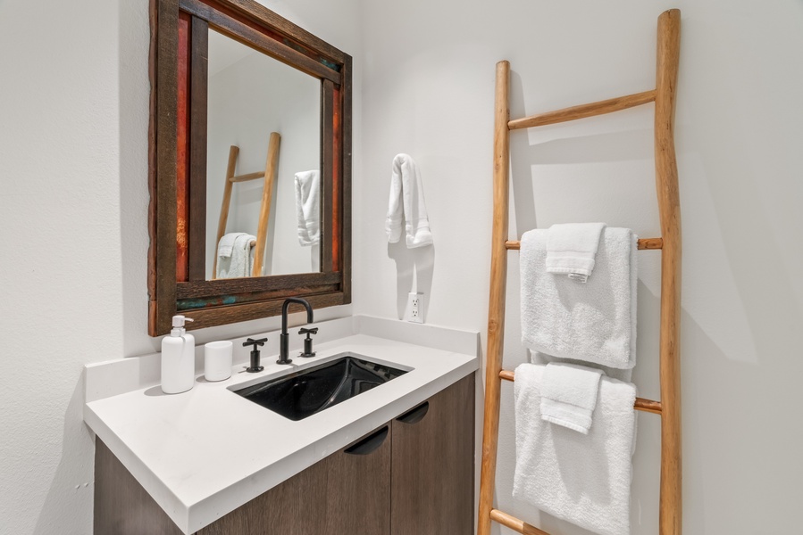 Rustic wood and modern fixtures bring warmth to this chic guest bath.