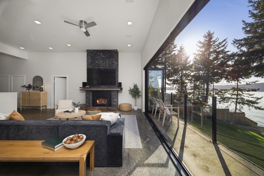 Bright and modern living area framed by panoramic windows — the bay feels just within reach.