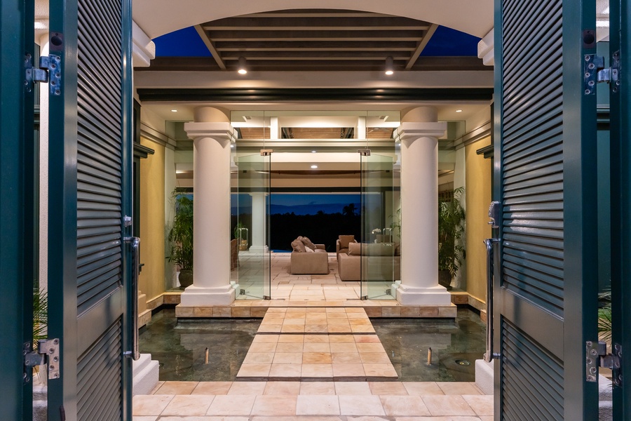 Elegant entryway with towering columns and glass accents, providing a grand welcome to the home.