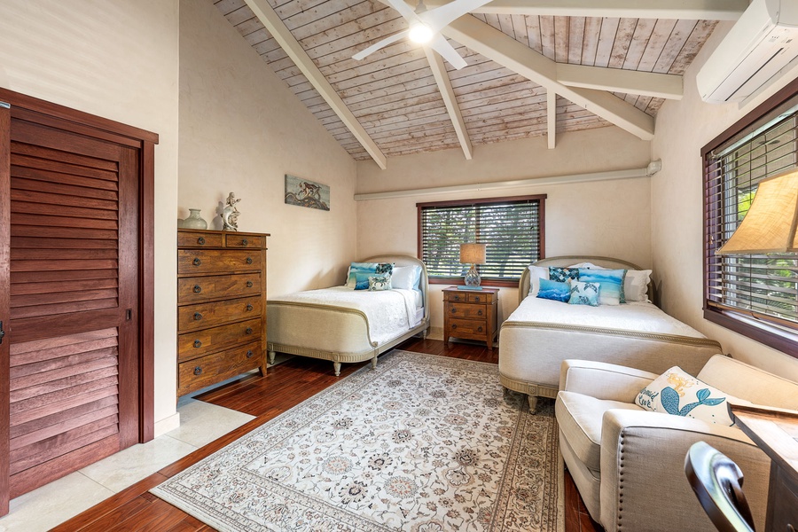 Spacious room with double beds and seating space—designed for comfort and privacy.