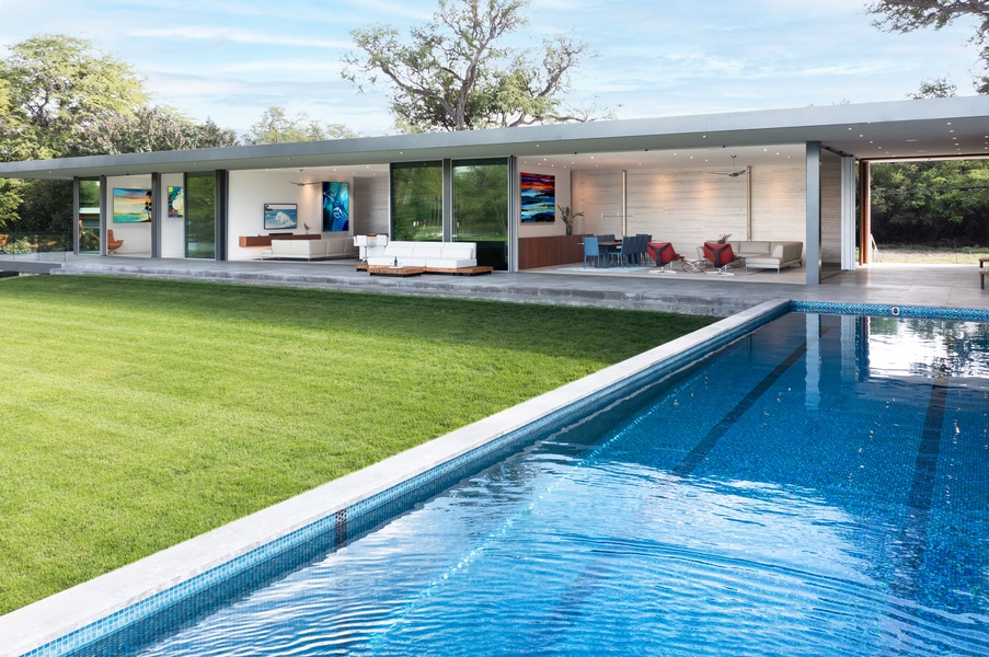 Enjoy seamless indoor-outdoor flow with a pristine pool overlooking a modern living space.