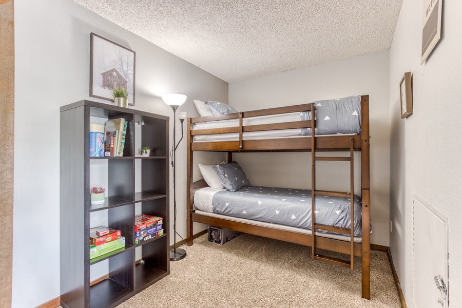 To the side of the central area is a bunk bed with two twin beds, a couch that folds into a full-size futon, a porta-crib