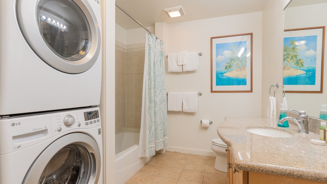 The second guest bathroom features a shower and washer / dryer combo.