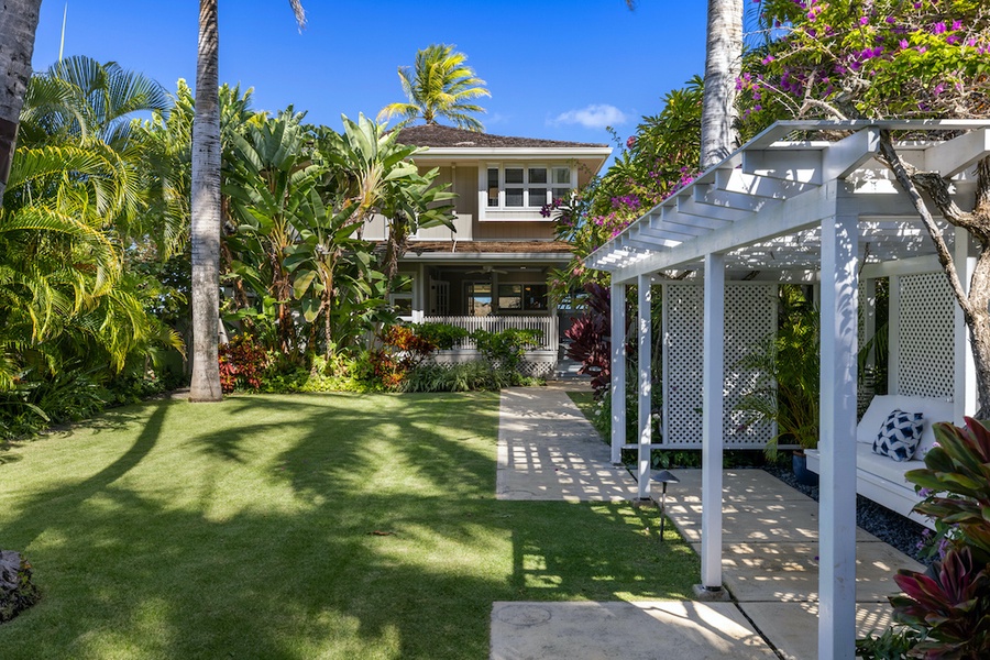 Beautifully appointed garden gazebo lined with Royal Palms