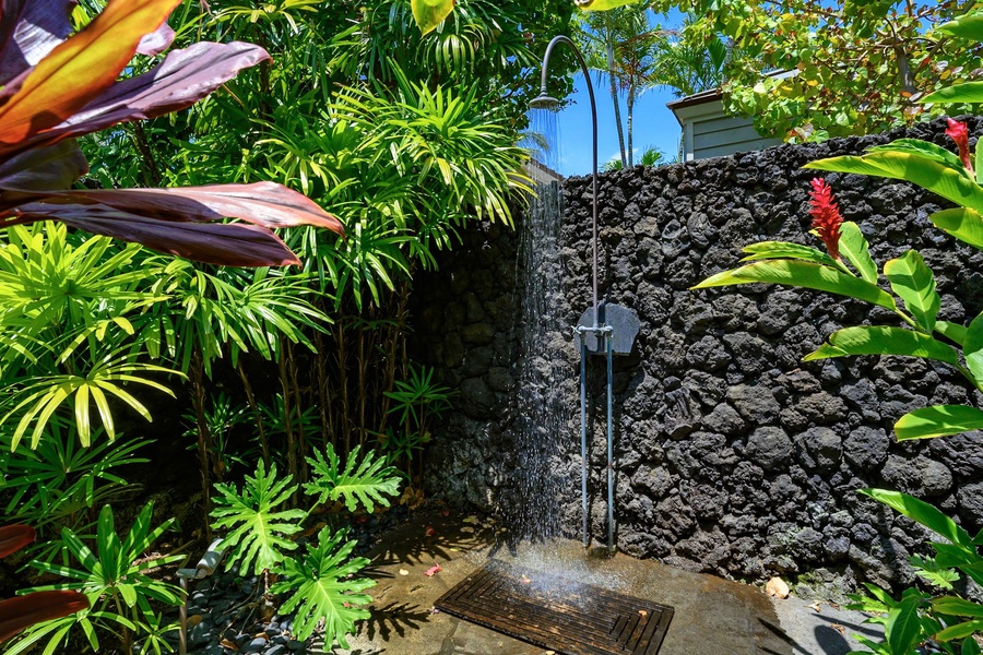 A unique feature is the private access to a lava rock wall outdoor shower, adding a touch of island charm.