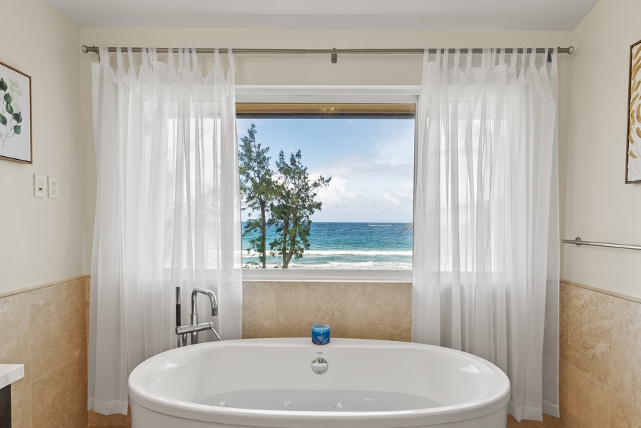 Soak in the tub while enjoying the stunning ocean view through the large window.