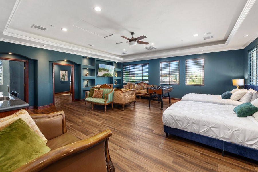 Wrapped in deep blue, this suite keeps its own quiet corner with a lounge by the bed.