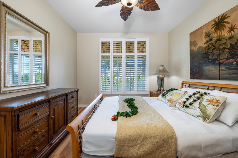 Sleep peacefully in a beautifully decorated primary bedroom with charming island-inspired decor.