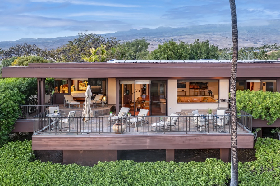 A rear view of the villa showcases its seamless indoor-outdoor design and architectural elegance.