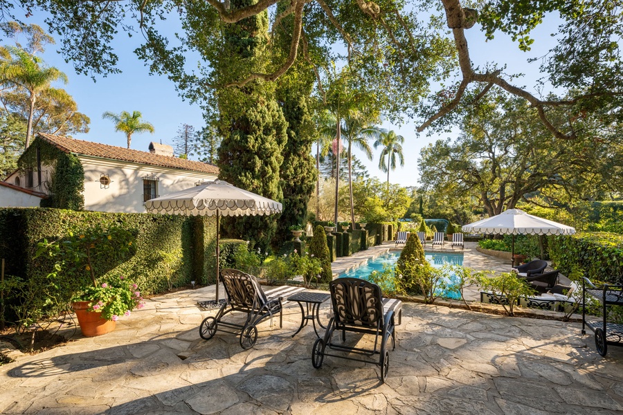 Relax by your private pool surrounded by lush gardens and elegant outdoor seating, where afternoon shade and sparkling water create the perfect retreat.