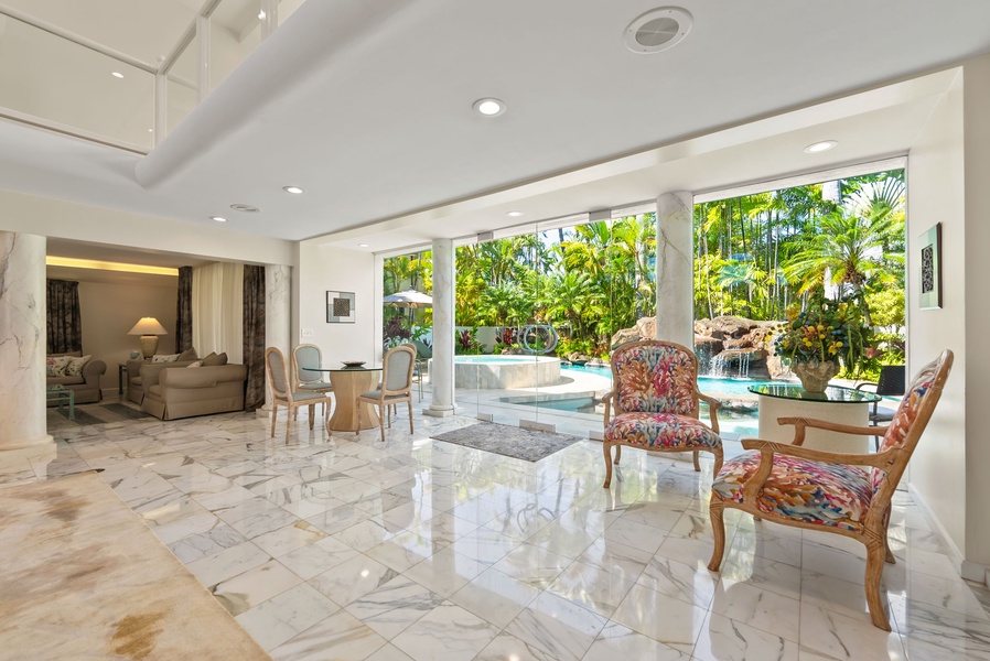 Bright sitting area with garden views, creating a cozy and inviting space to unwind indoors.