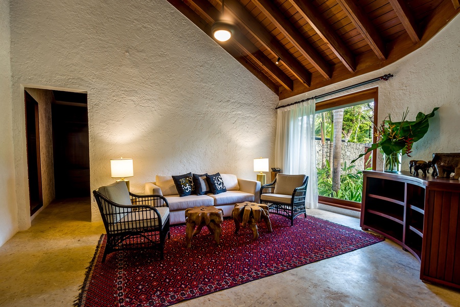 Gather in this cozy sitting area with natural light and garden view.