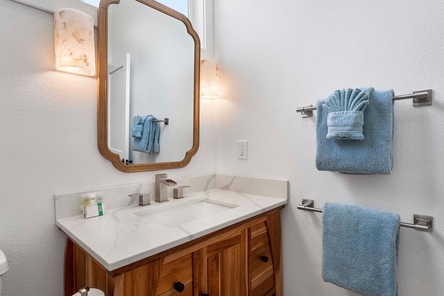 The guest ensuite bathroom has a single vanity area and a separate shower.