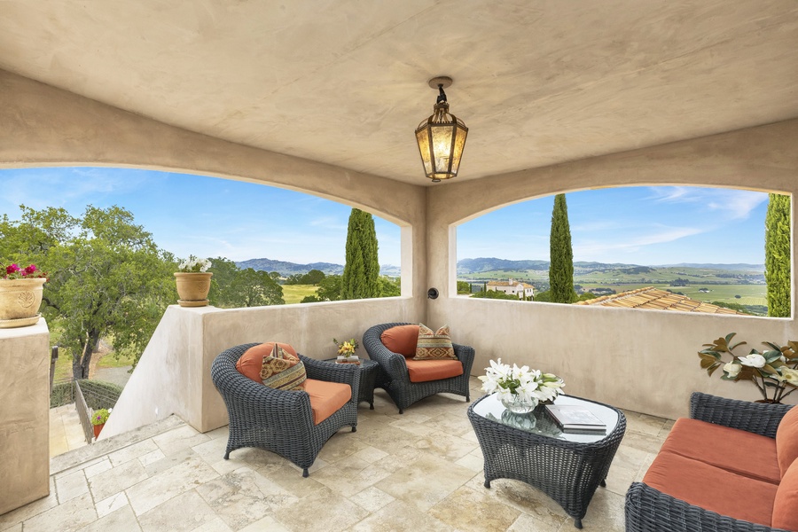 The estate home offers expansive patios and decks with stunning views on both floors