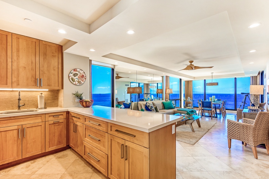 Open-concept kitchen seamlessly flows into the living and dining areas with ocean views.