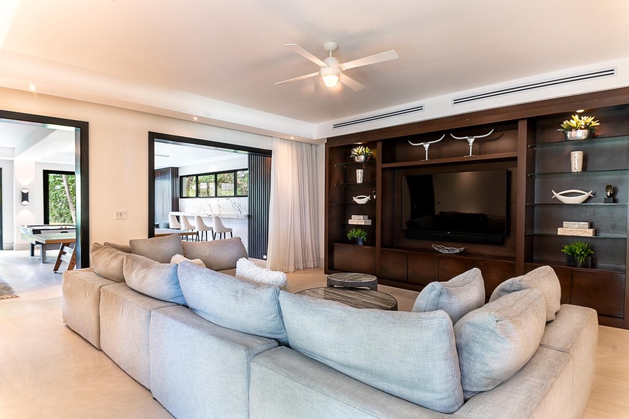 Stylish entertainment room with a comfortable sectional sofa and built-in media center.