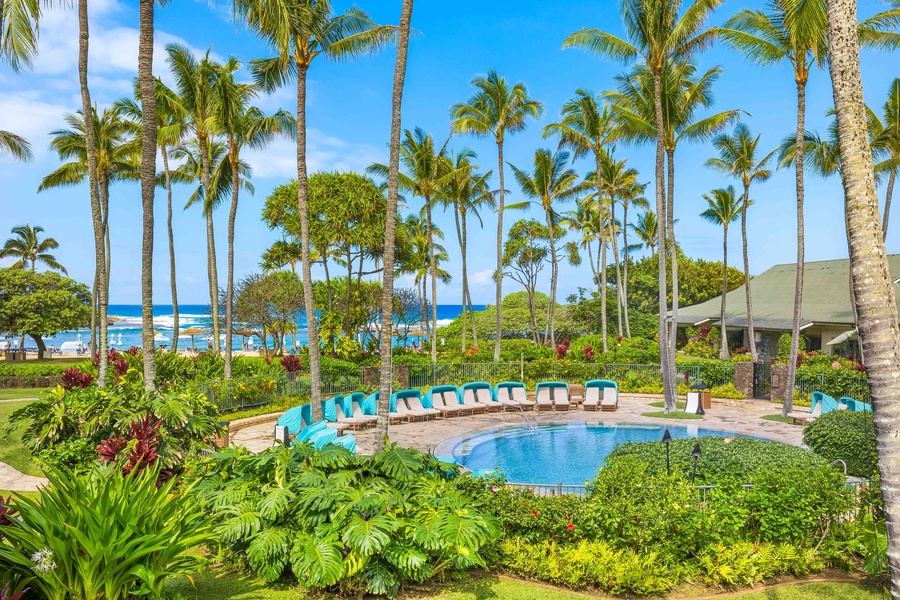 Tropical paradise awaits with a sparkling pool surrounded by swaying palms and vibrant gardens, just steps from pristine beaches.